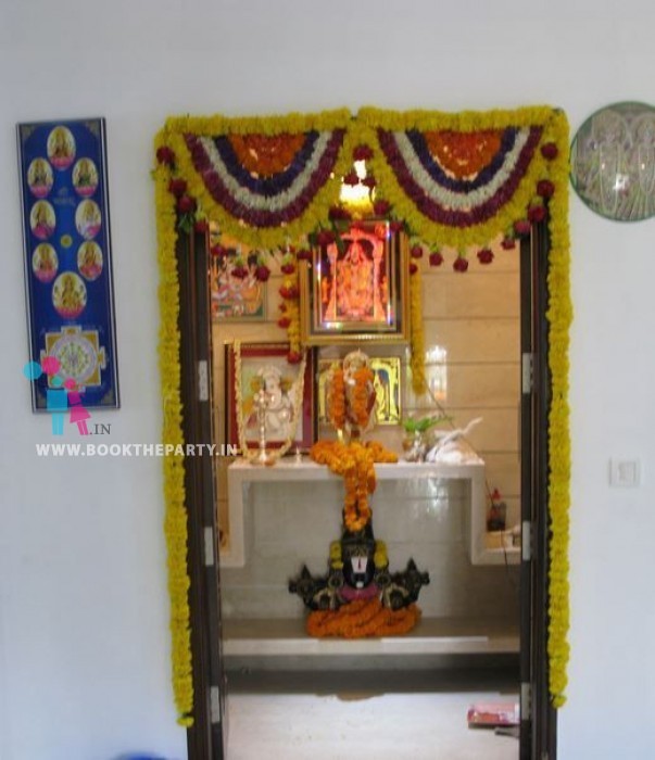 Image of Closeup Of Newly Constructed House Puja Room And Kitchen Decorated  With Garlands And Flower Due To Gruha Pravesham.-XN720827-Picxy